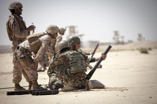 U.S. Marine Corps Staff Sgt. Gustavo Serpa, second from left, with the Regional Corps Battle School, watches as an Afghan National Army (ANA) mortarman shoots off a training practice round at a mortar range near Camp Shorabak, Helmand province, Afghanistan, May 4, 2013. Marines with the school trained the ANA soldiers to improve their proficiency with the 60 mm mortar system. (U.S. Marine Corps photo by Staff Sgt. Ezekiel R. Kitandwe/Released)