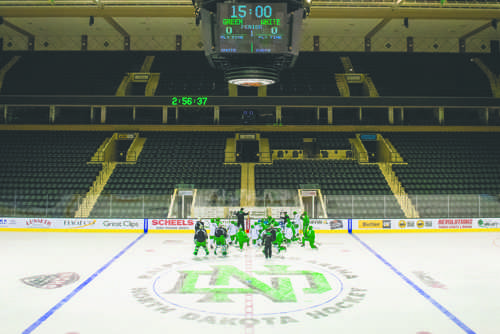 The UND mens hockey team gathers around head coach Brad Berry during practice at the Ralph Engelstad Arena on Friday, September 23, 2016.