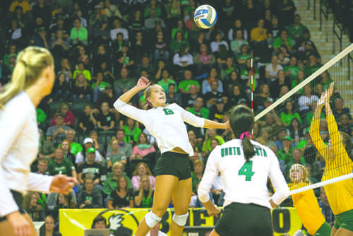 UND middle-hitter Faith Dooley prepares to spike back to NDSU during a game last season.