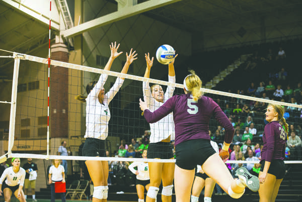 Sydney Griffin and Faith Dooley set up to block opponents during a match last season. Photo by Nick Nelson/ The Dakota Student