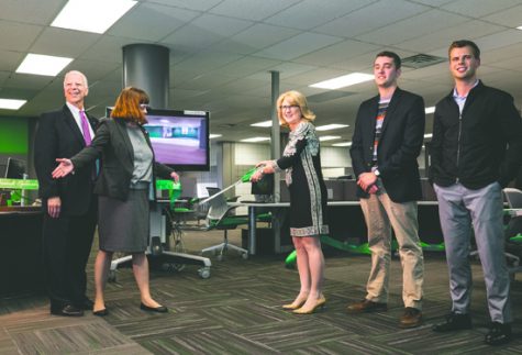 (From left) Provost Thomas DiLorenzo, Dean of Libraries Stephanie Walker, first lady Debbie Kennedy, student body vice president Blake Andert and president Brandon Beyer cut a ribbon celebrating the first floor renovation of the Chester Fritz Library on Tuesday, October 25, 2016.