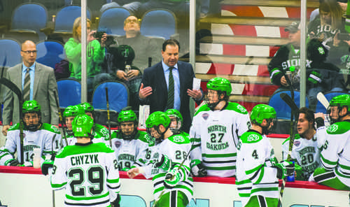 Head coach Brad Berry speaks to the mens hockey team during a time-out during the Frozen Faceoff match against University of Minnesota Duluth at the Target Center on March 18, 2016.