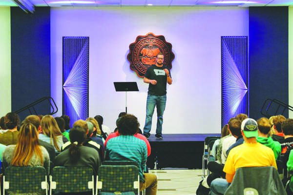 UND student Luke Matthewson speaks to a group of students about his religious faith Tuesday evening at the Memorial Union ballroom.