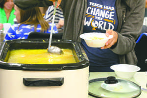 A UND student ladles up soup during a Soup Friday luncheon at the American Indian Student Services Center (AISS) on Friday.