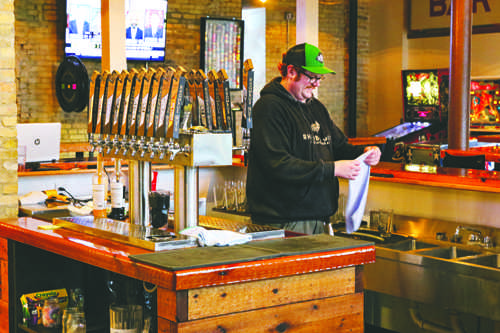 Steve Cowger cleans the bar at Rhombus Guys Brewing Company in downtown Grand Forks on Tuesday, October 4, 2016