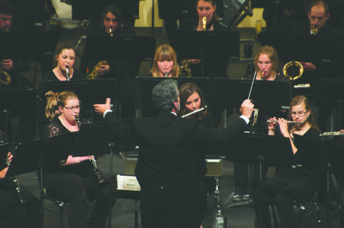 Dr. James Popejoy directs the UND Wind Band Ensemble during a concert Tuesday evening at the Chester Fritz Auditorium.