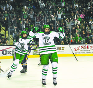 Tyson Jost (right) and Shane Gersich (left) celebrate Josts first UND career goal Friday evening against Canisius University at the Ralph Engelstad Arena.