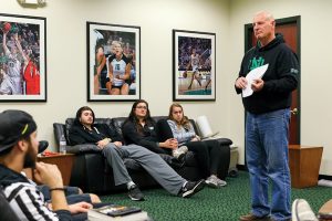 UND student athletes (on sofa) Conner Avants, Fallyn Freije and Bailey Strand listen as Ev Nelson (right) leads a Fellowship of Christian Athletes (FCA) meeting Monday evening at the Betty Engelstad Sioux Center.