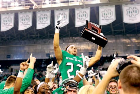 Running back John Santiago celebrates UND's Big Sky conference championship after defeating Northern Arizona University last Saturday at the Alerus Center.