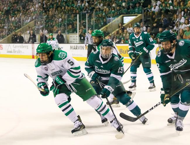 Freshman defender Casey Johnson chases the puck against Bemidji State at the Ralph Engelstad Arena on Saturday, Oct. 22.