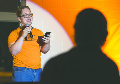 Jared Fladeland performs poetry and spoken word during the Koselig concert at the University Park warming house on Saturday evening. Nick Nelson/ Dakota Student