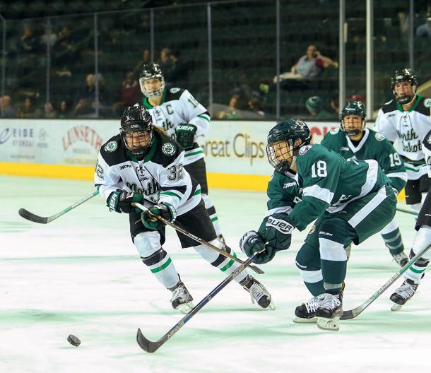 Hallie Theodosopoulos chases the puck as Bemidji State's Lisa Laiti attempts to block her earlier this season at the Ralph Engelstad Arena.