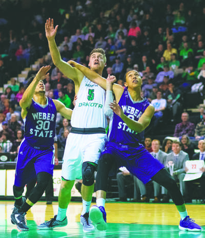 UND junior center Carson Shanks tussles with Weber State's Jeremy Senglin (left) and Jordan Dallas (right) during a game in January at the Betty Engelstad Sioux Center. Nick Nelson/ Dakota Student