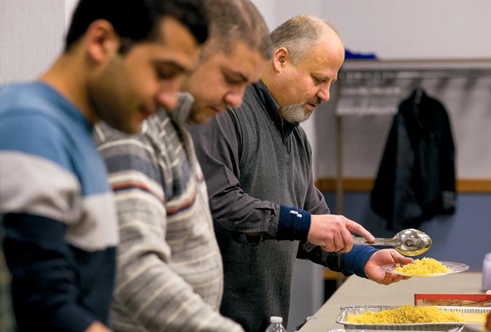 Nabil Suleiman, associate professor of civil engineering, serves rice during a "Lunch with a Muslim" event in the Memorial Union as part of Interfaith week.