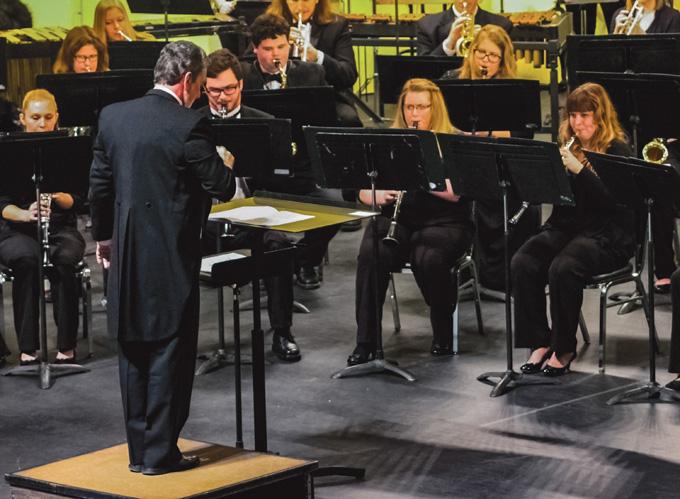 Dr. James Popejoy (left) conducts the UND Wind Ensemble and University Band during Tuesdays concert at the Chester Fritz Auditorium.