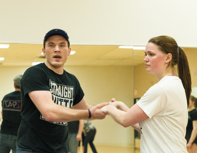 Tyler Bye-Jehns demonstrates a dance move with Emily Makaruk during a swing dance class on Thursday, March 30, 2017.