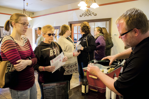 Guests sample wine at Mamma Maria's during Saurday's Art & Wine Walk.