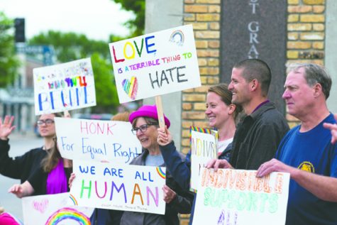 Rally goers wave hand-painted signs during an equality rally on Saturday in East Grand Forks, M.N. Nick Nelson/Dakota Student
