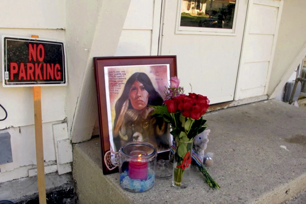 A makeshift memorial to Savanna LaFontaine-Greywind outside the apartment where she lived with her parents in Fargo, N.D. has flowers, a painting, candle and stuffed animal on Aug. 28, 2017. (Dave Kolpack/Associated Press)