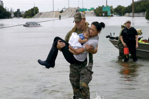 Houston Police SWAT officer Daryl Hudeck carries Catherine Pham and her 13-month-old son Aiden after rescuing them from their home surrounded by floodwaters from Tropical Storm Harvey Sunday, Aug. 27, 2017, in Houston. The remnants of Hurricane Harvey sent devastating floods pouring into Houston Sunday as rising water chased thousands of people to rooftops or higher ground.