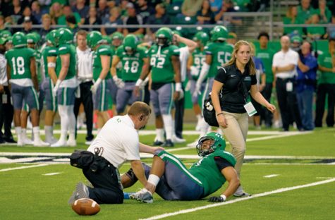 UND inside linebacker Donnell Rodgers winces in pain as a trainer attends to his injured knee during the 2017 Potato Bowl game against Missouri State on Saturday, September 9, 2017.
