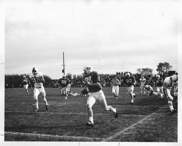 An action photograph of UND Football player, Bill Predovich #89, at the UND vs Idaho State game on September 24, 1966. Elwyn B. Robinson Department of Special Collections