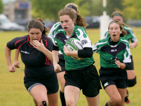 UND's Brooke Johnson breaks away from the MSUM defense during Saturday's rugby match. The Sweet Demons ended the match with a 26-10 victory.