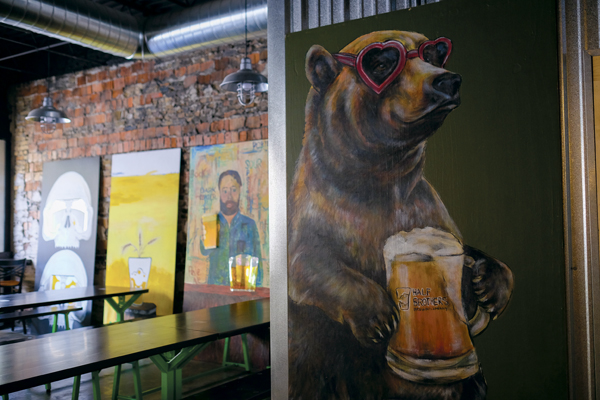 Half Brothers Brewing Company offers a taproom open to all ages featuring local art and custom-made furniture.