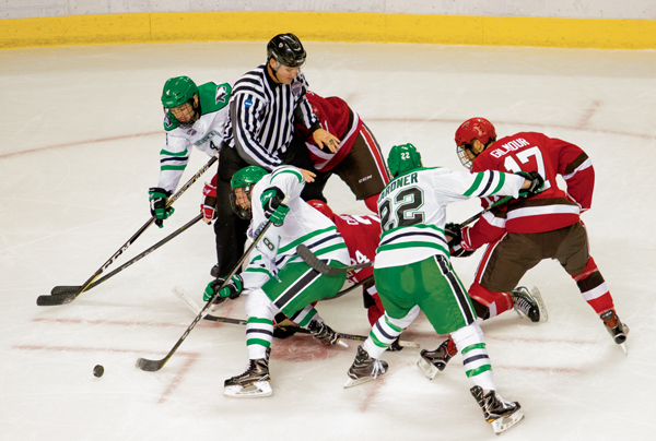 UND forward Nick Jones (#8) breaks away from a face-off against St. Lawrence Friday night at the Ralph Engelstad Arena. The Fighting Hawks swept the Saints in a two game series.