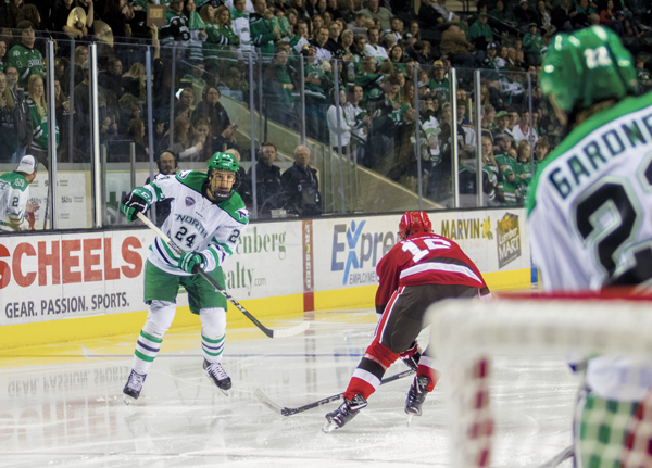 UND defender Christian Wolanin fires a shot towards the St. Lawrence goal during a home game earlier this season.