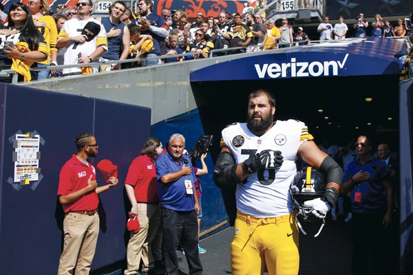 Alejandro Villanueva (#78) of the Pittsburgh Steelers stands by himself in the tunnel for the national anthem prior to the game against the Chicago Bears at Soldier Field on September 24, 2017 in Chicago, Illinois. 