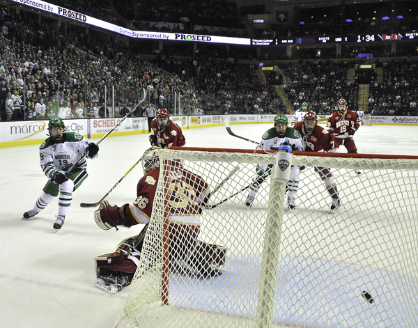 UNDs Shane Gersich (#19) fires a shot past Denver goaltender Tanner Jaillet during a home series last season.