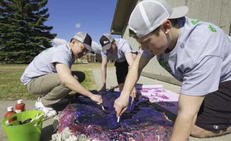 (From left) Alan Ju, Alex Widner and Devin Reifsteck paint angry clouds during the Big Event on Saturday morning. 