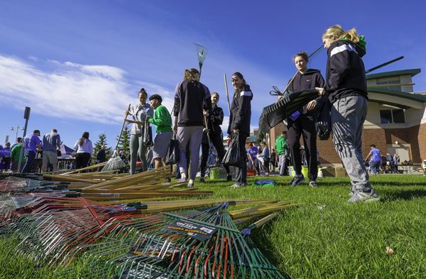 Members of the Fighting Hawks womens basketball team pick up rakes and other tools prior to volunteering for The Big Event last year. 