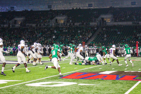 Football players tackle each other during game at the Alerus
