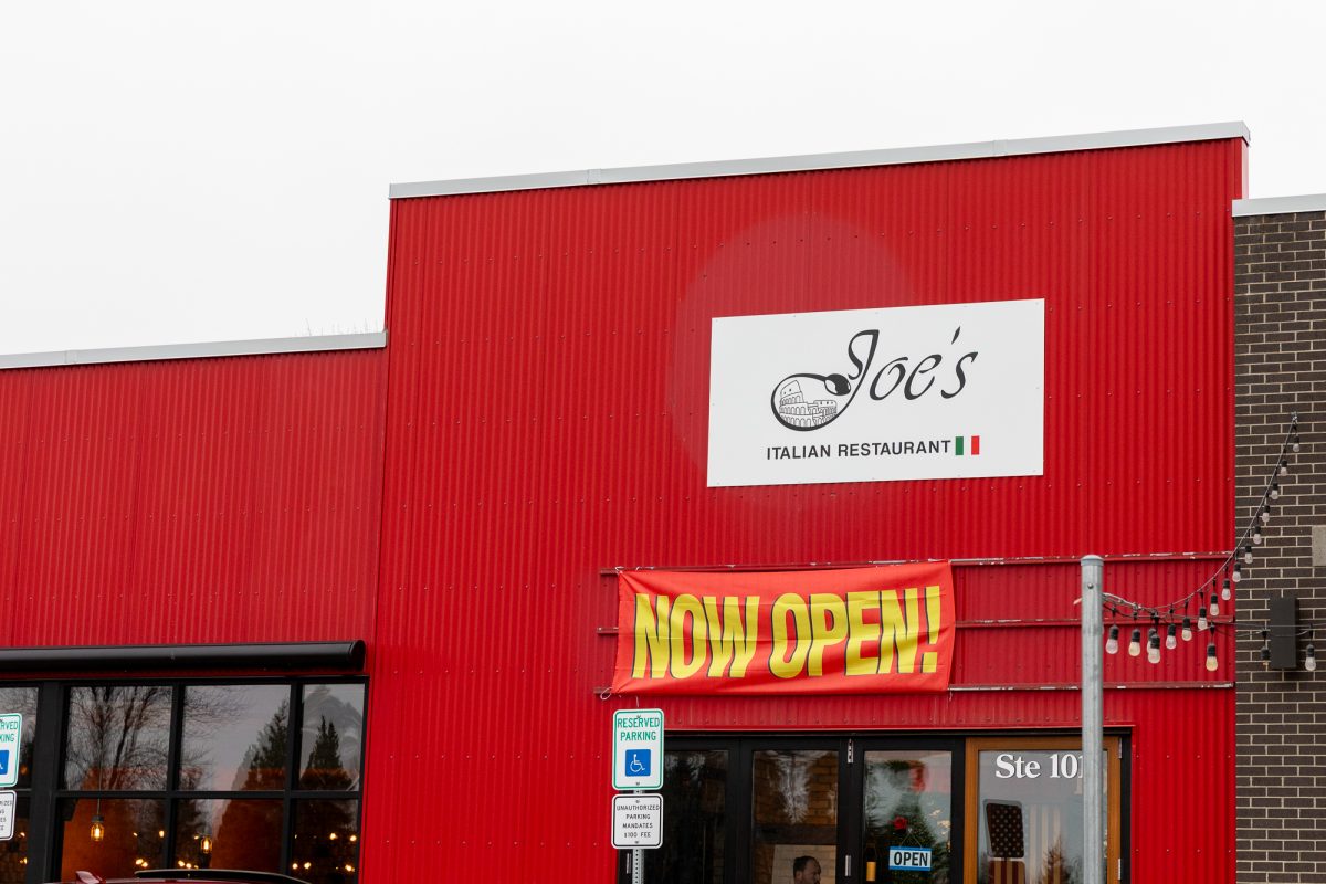 Joe's new restaurant with a "now open" sign.